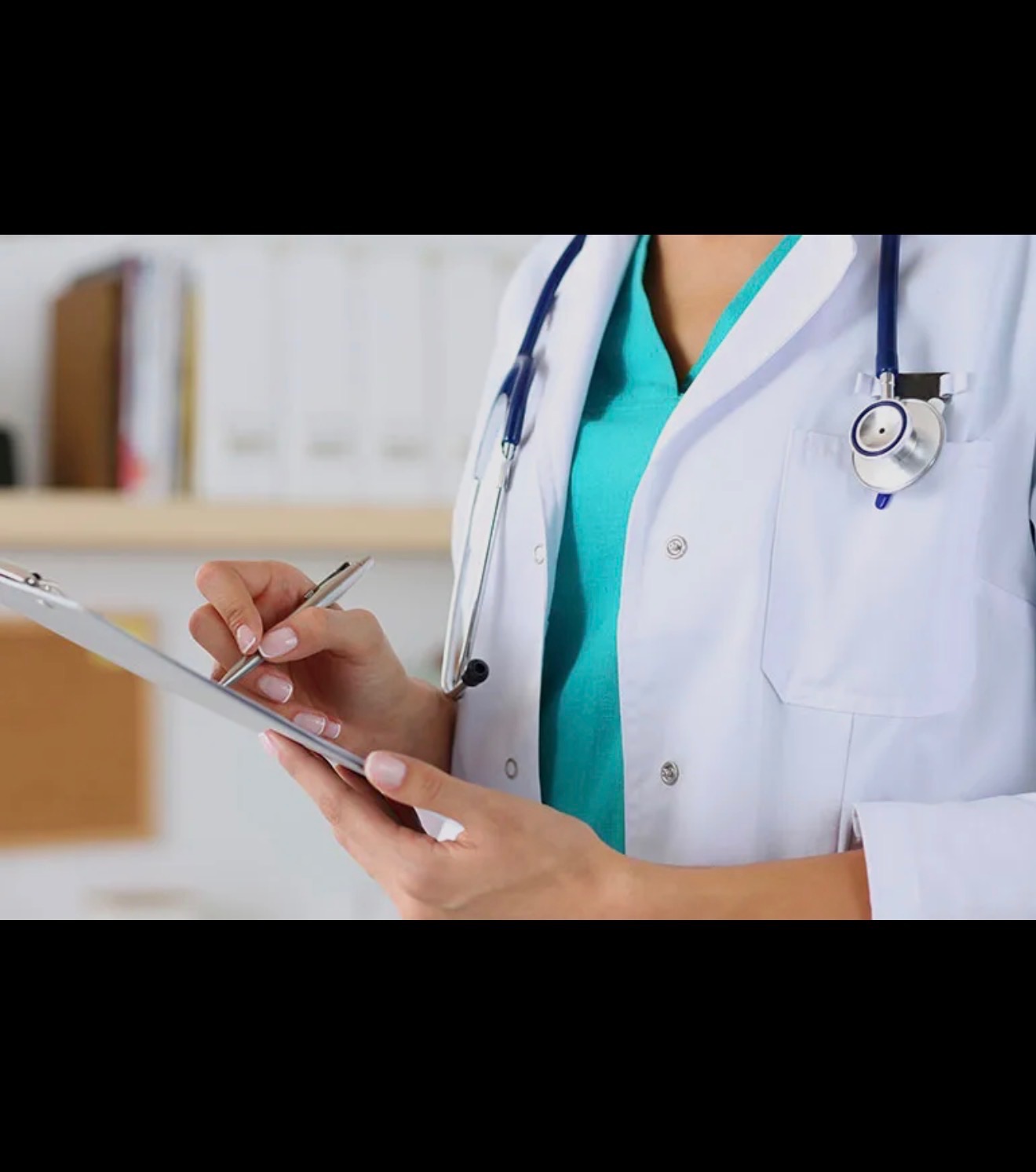 A clinician writes notes on a medical clipboard.